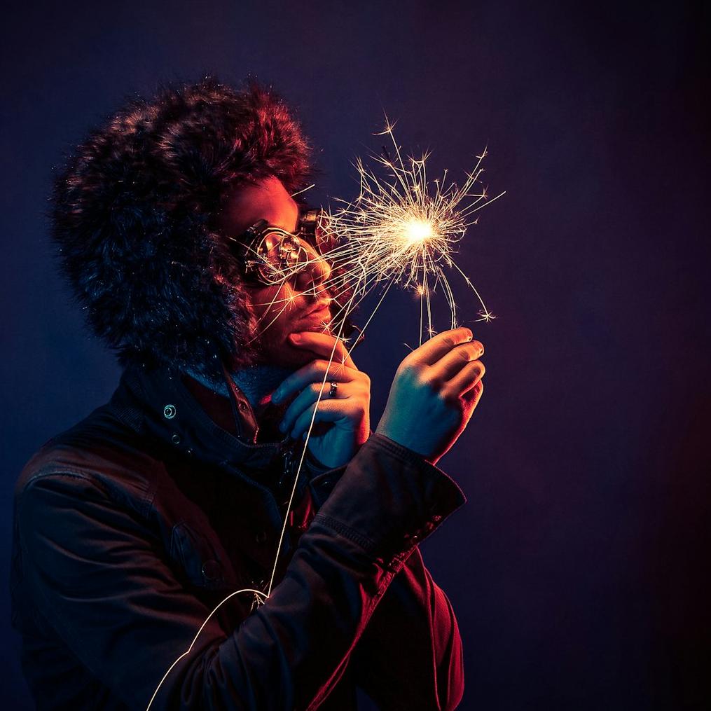 man in black jacket holding spark