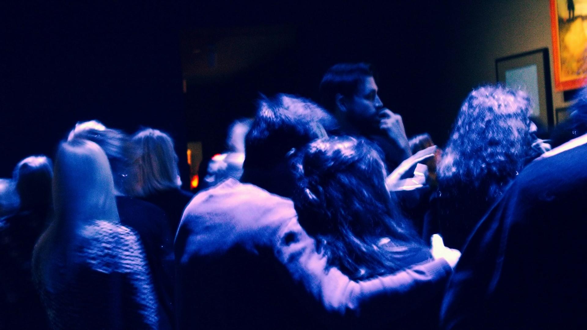 a group of people standing around each other