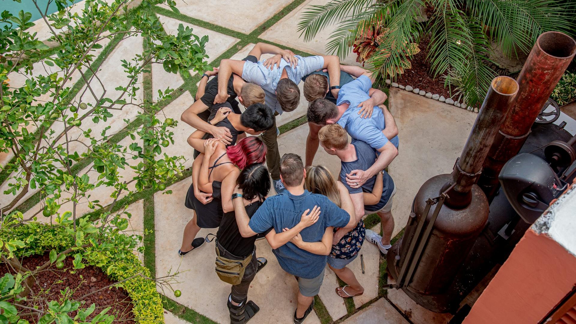 group of people sitting on concrete floor